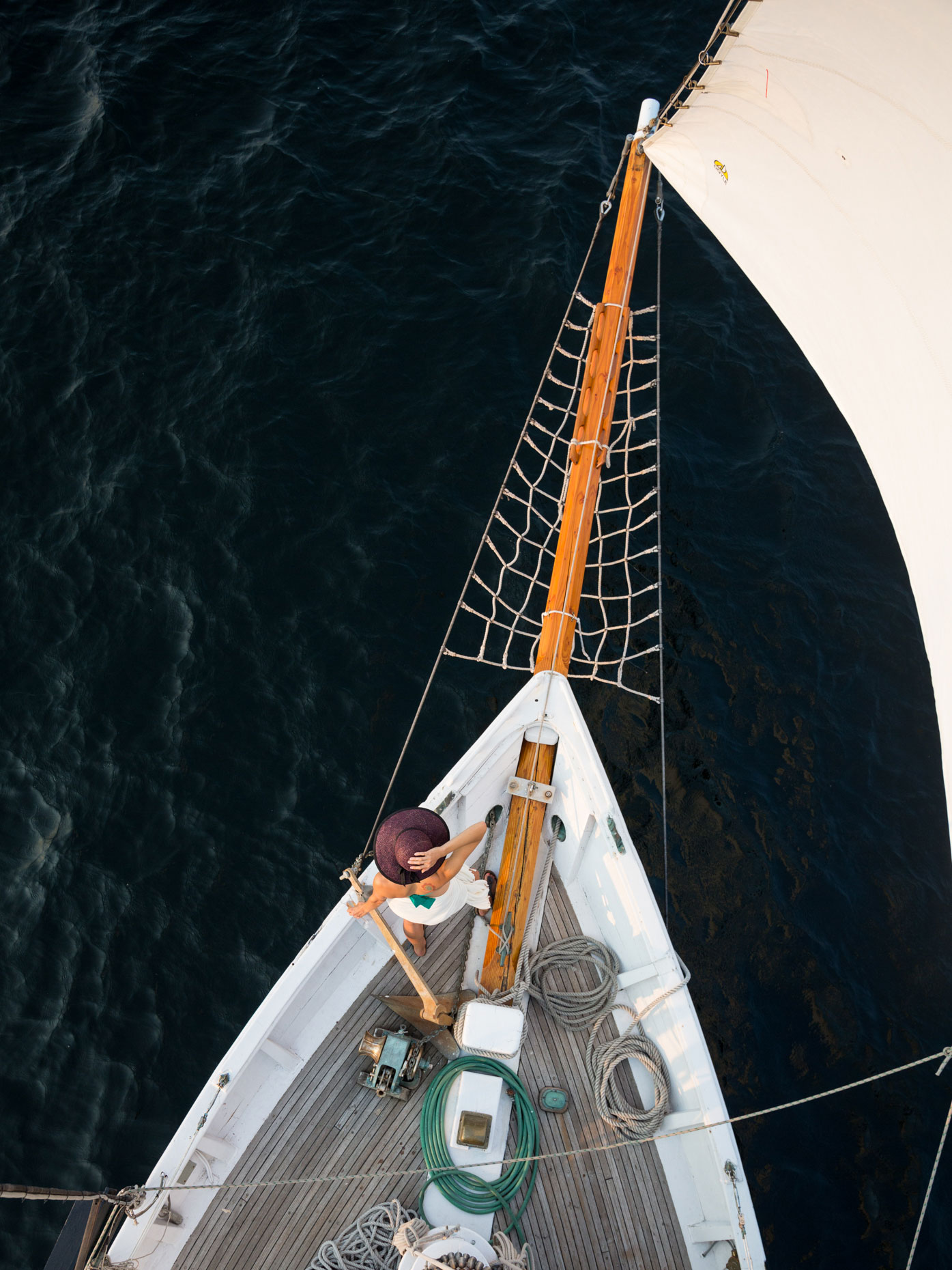 Woman at bow of sailing boat